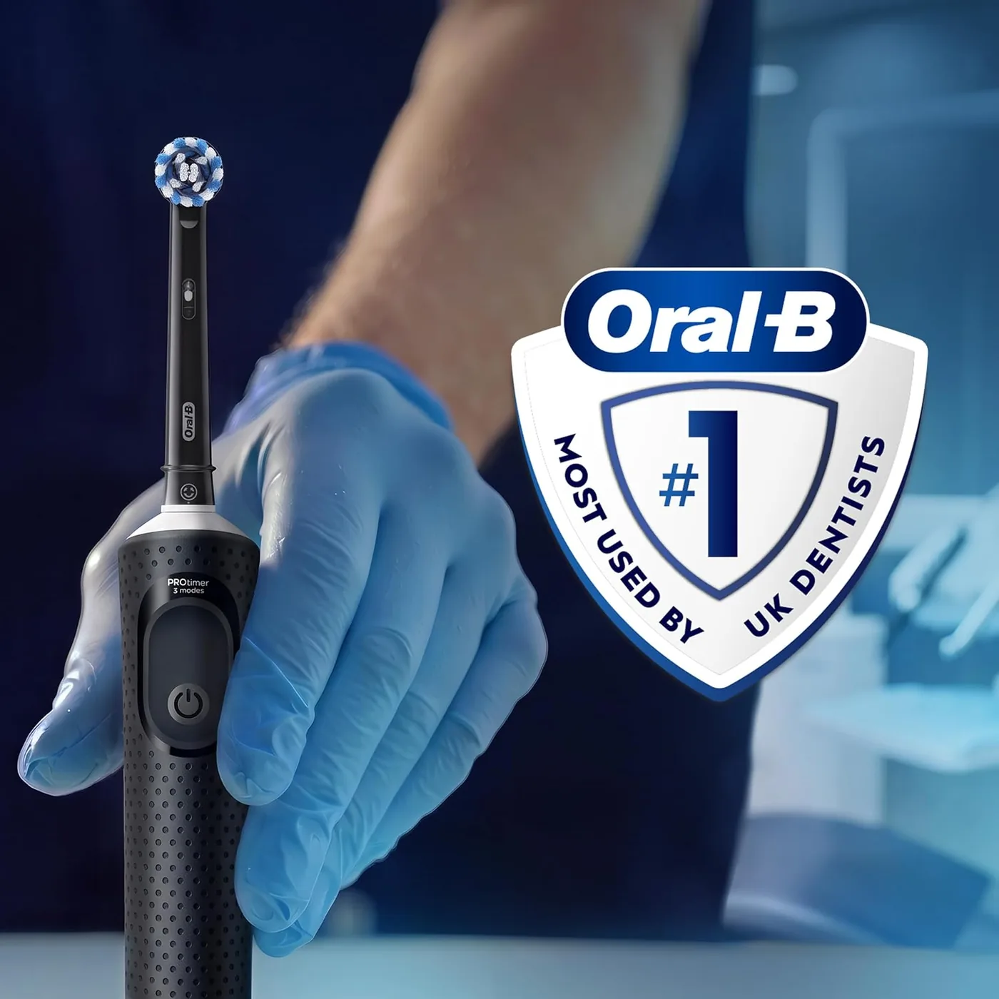 Person holding the Oral-B Vitality Pro in a gloved hand beside the Oral-B dentist badge